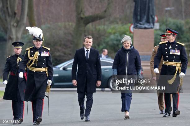 French President Emmanuel Macron and Britain's Prime Minister Theresa May arrive to review an honour guard at the Royal Military Academy Sandhurst,...