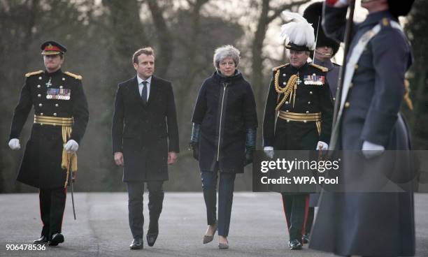 Prime Minister Theresa May and French President Emmanuel Macron view a guard of honour ahead of UK-France summit talks at the Royal Military Academy...