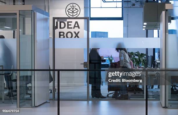 Employees work in a glass walled office as Robert Bosch GmbH opens an Internet of Things campus in Berlin, Germany, on Thursday, Jan. 18, 2018....