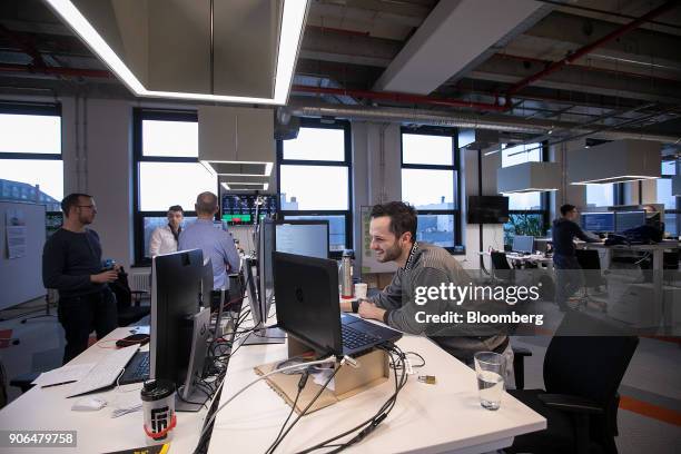 Employees stand at desks as Robert Bosch GmbH opens an Internet of Things campus in Berlin, Germany, on Thursday, Jan. 18, 2018. Germanys largest...