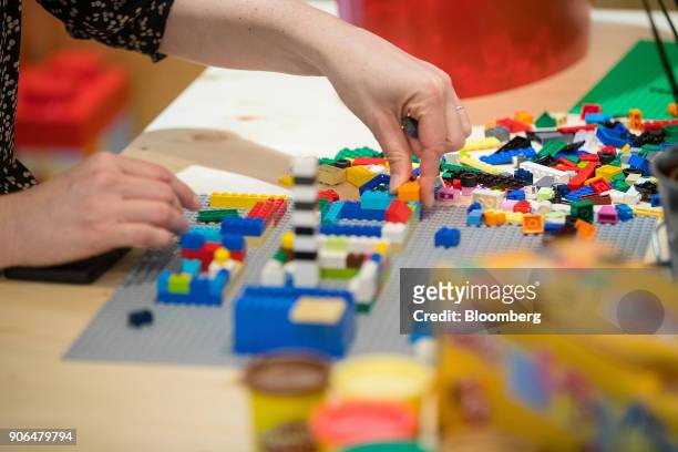 An employee assembles a model with Lego A/S toy bricks in a rest area during the opening of the Robert Bosch GmbH Internet of Things campus in...