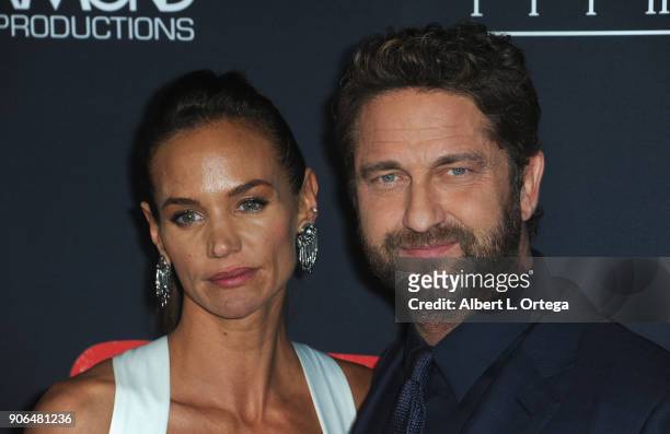 Actor Gerard Butler and Morgan Brown arrive for the Premiere Of STX Films' "Den Of Thieves" held at Regal LA Live Stadium 14 on January 17, 2018 in...