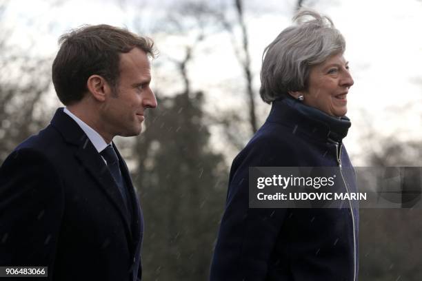 French President Emmanuel Macron and Britain's Prime Minister Theresa May arrive to review an honour guard at the Royal Military Academy Sandhurst,...