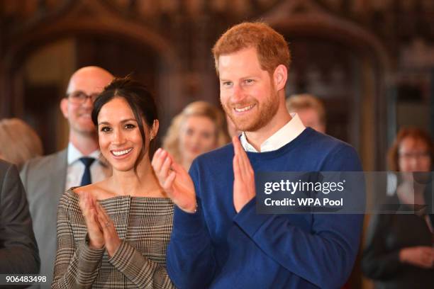 Prince Harry and his fiancee Meghan Markle watch a performace during their visit to Cardiff Castle on January 18, 2018 in Cardiff, Wales.