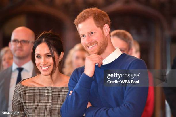 Prince Harry and his fiancee Meghan Markle watch a performace during their visit to Cardiff Castle on January 18, 2018 in Cardiff, Wales.