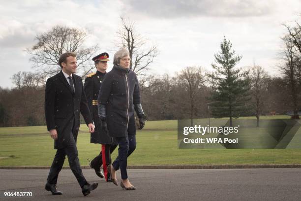 Prime Minister Theresa May and French President Emmanuel Macron arrive to view a guard of honour ahead of UK-France summit talks at the Royal...