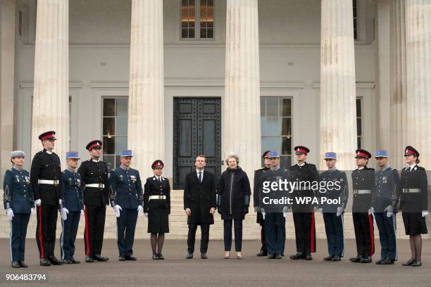 Prime Minister Theresa May and French President Emmanuel Macron join English and French service personnel ahead of UK-France summit talks at the...