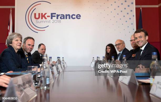 Prime Minister Theresa May and French President Emmanuel Macron attend a plenary session ahead of UK-France summit talks at the Royal Military...