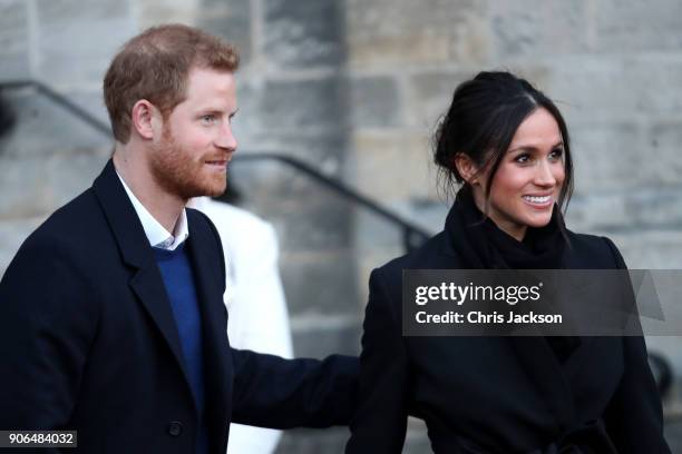 Prince Harry and his fiancee Meghan Markle depart from a walkabout at Cardiff Castle on January 18, 2018 in Cardiff, Wales.