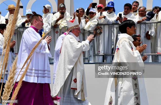 Pope Francis waves after celebrating an open-air mass at Lobitos Beach, near the Chilean northern city of Iquique, on January 18, 2018. - Pope...