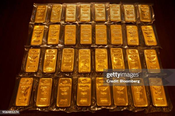 Thirty two, one kilogram bars of gold, worth a total of approximately one million British pounds sit on a table at the Sharps Pixley Ltd. Showroom in...