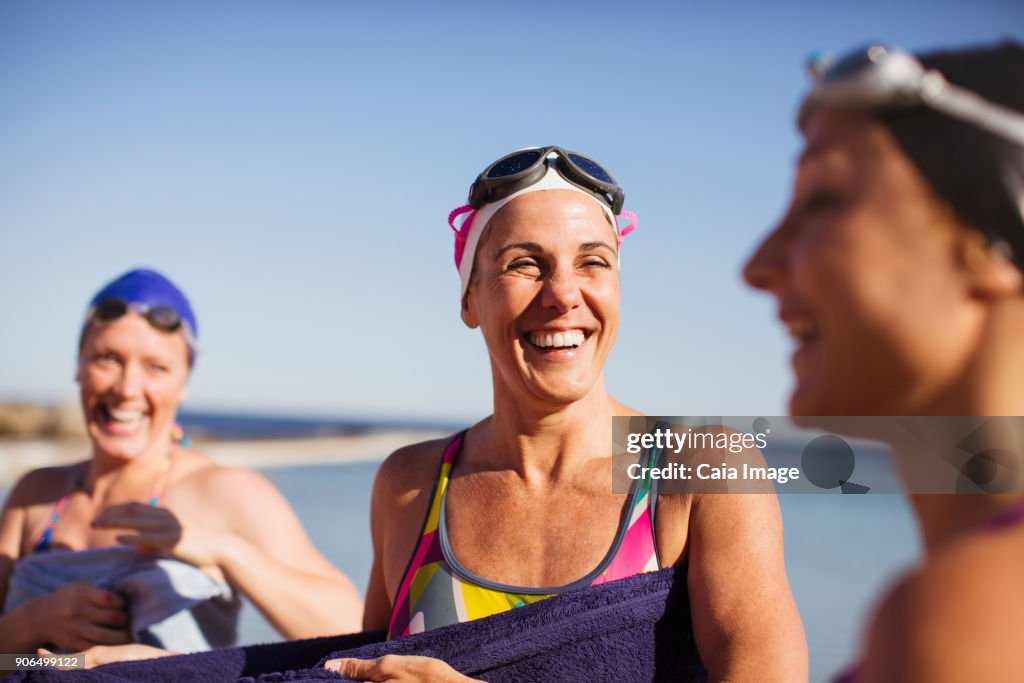 Laughing female open water swimmers