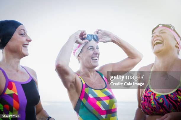 laughing female open water swimmers - open water swimming stock pictures, royalty-free photos & images