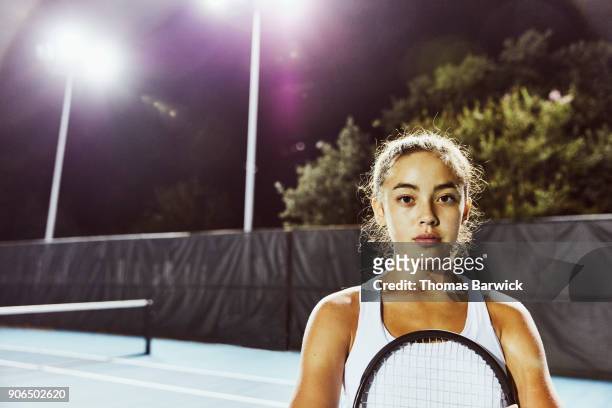 portrait of teenage female tennis player after practice on outdoor court at night - tennis 2017 stock-fotos und bilder
