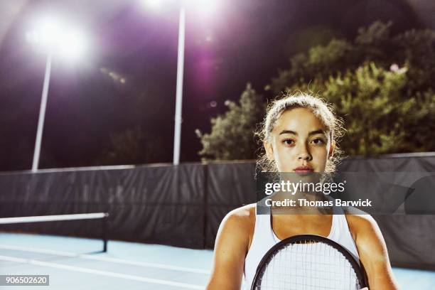 portrait of teenage female tennis player after practice on outdoor court at night - teenager attitude stock pictures, royalty-free photos & images