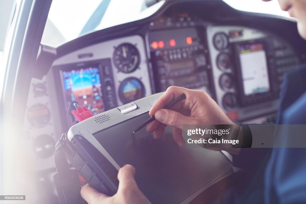 Pilot Using Computer Airplane Pilot Using Stylus On Digital Tablet In Cockpit High-Res Stock ...