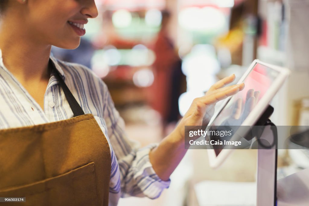 Female Cashier Using Touch Screen Cash Register In Grocery Store High ...