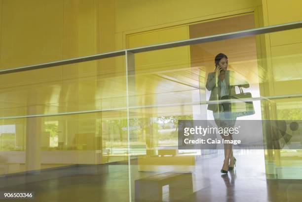 business people handshaking in distance in modern office lobby corridor - first exposure series stock pictures, royalty-free photos & images