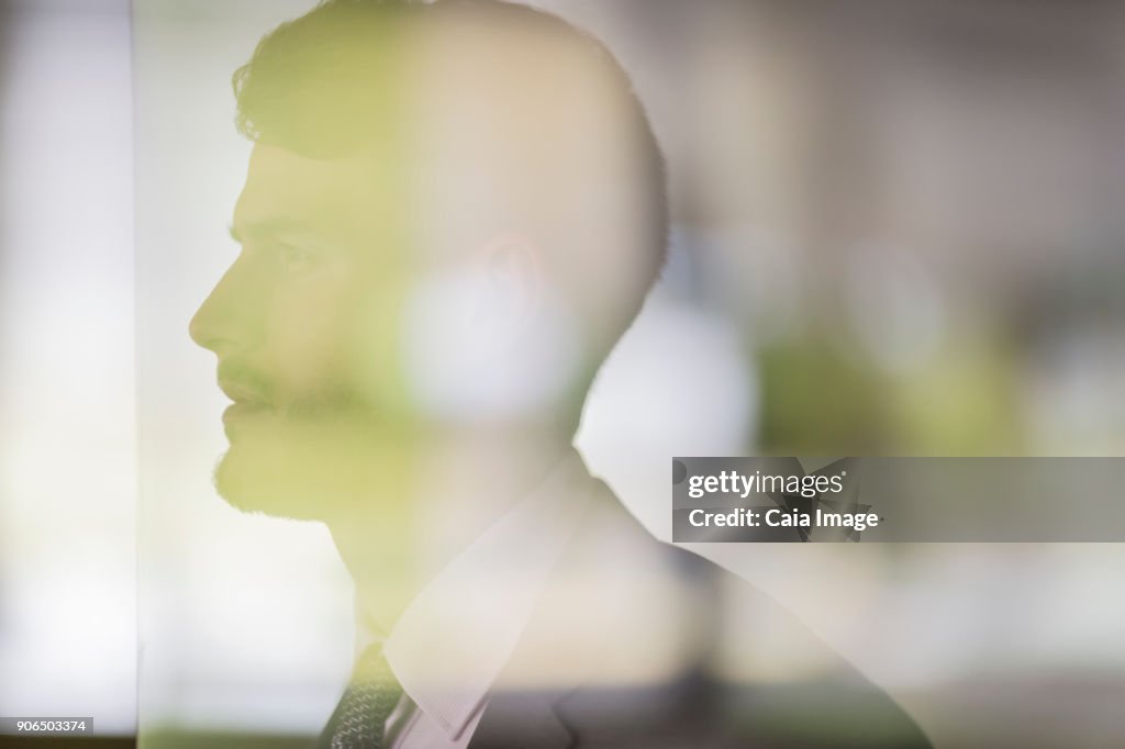 Portrait serious scientist in clean suit using digital tablet