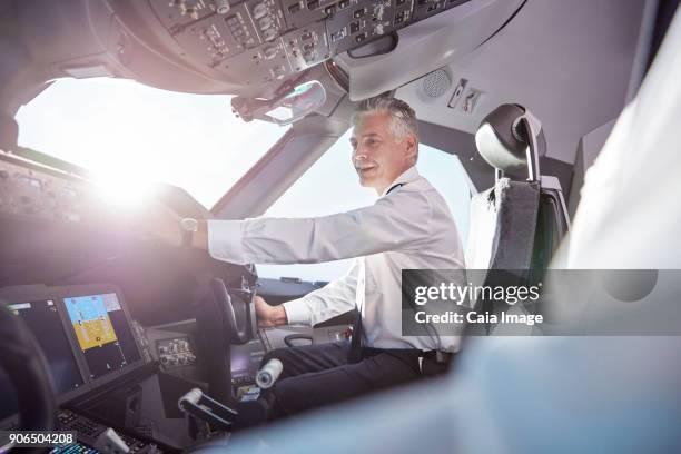 smiling male pilot in airplane cockpit - flight-instruments stockfoto's en -beelden