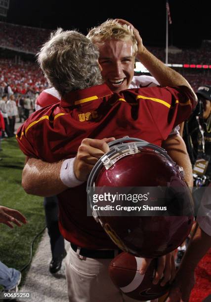 Head coach Pete Carroll hugs Matt Barkley of the Southern California Trojans after defeating the Ohio State Buckeyes 18-15 on September 12, 2009 at...