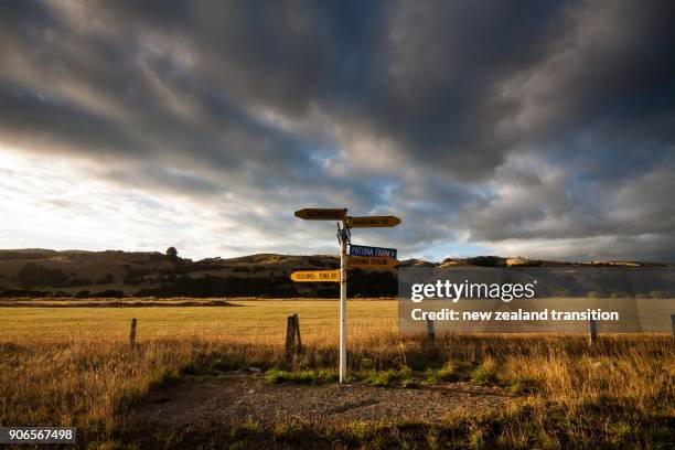 street sign in golden sunrise light with dramatic cloudy sky in background in rural wairarapa - new zealand rural bildbanksfoton och bilder