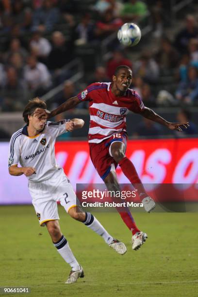 Atiba Harris of FC Dallas heads a loose ball over Todd Dunivant of the Los Angeles Galaxy during their MLS game at The Home Depot Center on September...