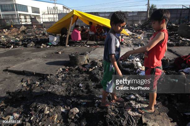 Residents scavenge whats left of houses after a fire broke out in Taguig City, south of Manila,Philippines, on Thursday, 18 January 2018. The fire...