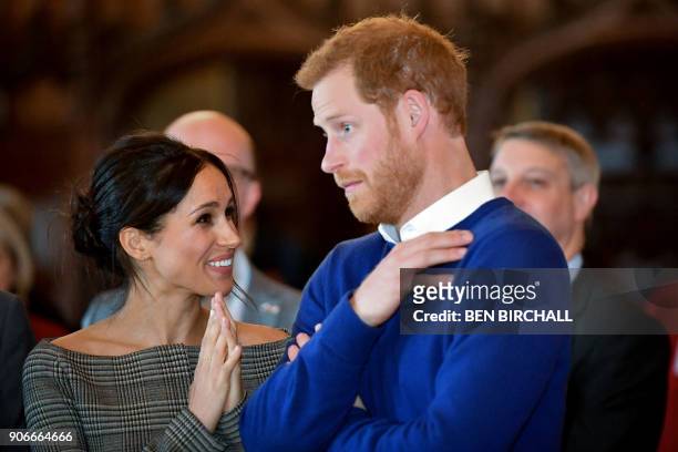 Britain's Prince Harry and his fiancée US actress Meghan Markle watch a dance performance by Jukebox Collective in the banqueting hall during a visit...