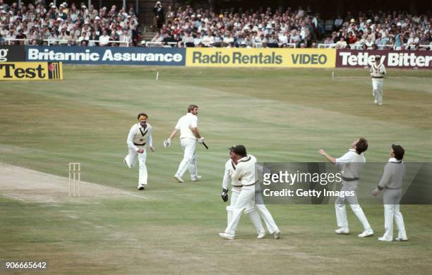 England batsman Ian Botham leaves the field after being dismissed in the 1st Innings, caught behind by Rodney Marsh off the bowling of Dennis Lillee...