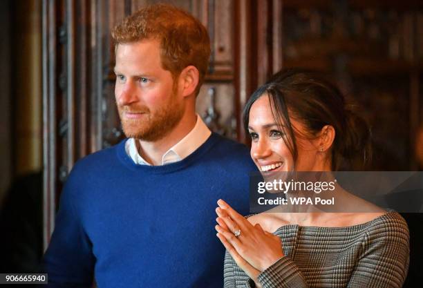 Prince Harry and Meghan Markle watch a performance by a Welsh choir in the banqueting hall during a visit to Cardiff Castle on January 18, 2018 in...
