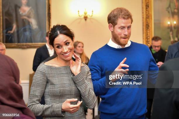 Prince Harry and Meghan Markle chat with people inside the Drawing Room during a visit to Cardiff Castle on January 18, 2018 in Cardiff, Wales.