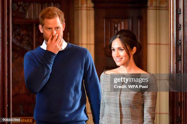 Prince Harry and Meghan Markle arrive in the banqueting hall during a visit to Cardiff Castle on January 18, 2018 in Cardiff, Wales.