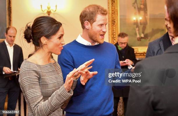 Prince Harry and Meghan Markle chat with people inside the Drawing Room during a visit to Cardiff Castle on January 18, 2018 in Cardiff, Wales.