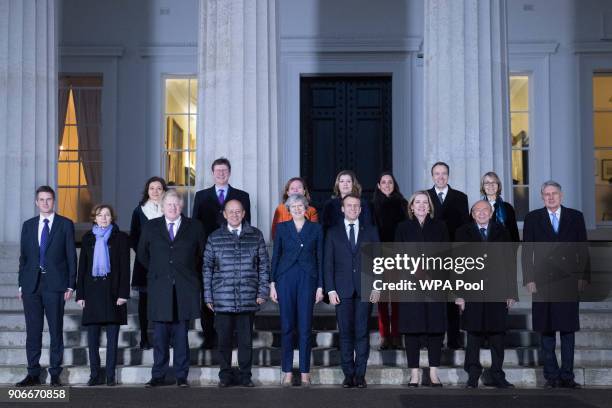 Prime Minister Theresa May and French President Emmanuel Macron pose for a 'family photograph' at the Royal Military Academy Sandhurst on January 18,...