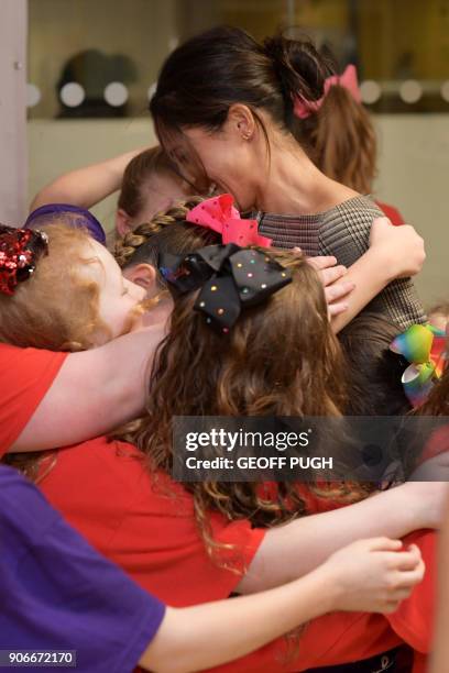 Britain's Prince Harry and his fiancée US actress Meghan Markle attend a street dance class during their visit to Star Hub community and leisure...