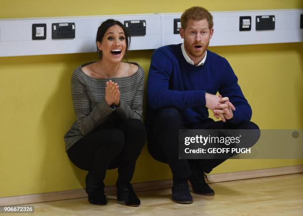 Britain's Prince Harry and his fiancée US actress Meghan Markle attend a street dance class during their visit to Star Hub community and leisure...