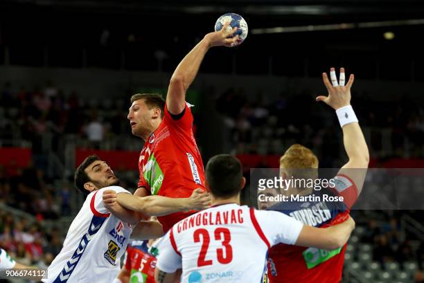 Petar Nenadic of Serbia challenges harald Reinkind of Norway during the Men's Handball European Championship main round match between Serbia and...