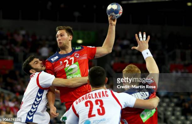 Petar Nenadic of Serbia challenges harald Reinkind of Norway during the Men's Handball European Championship main round match between Serbia and...