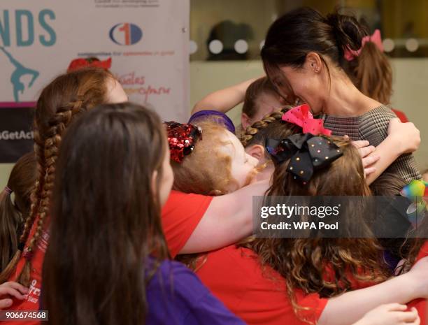 Meghan Markle in a group hug as she attends a street dance class during her visit to Star Hub on January 18, 2018 in Cardiff, Wales.