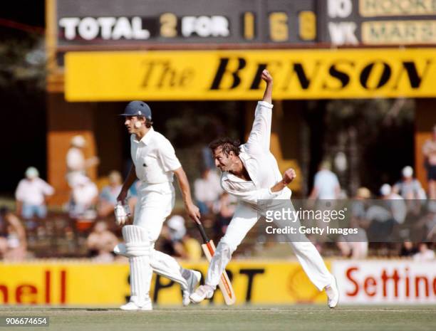 Australia bowler Dennis Lillee in action as non striking England batsman Chris Tavare looks on during the opening day of the 1982/83 Ashes series at...