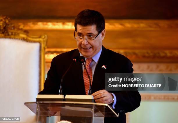 Paraguayan President Horacio Cartes speaks at a ceremony at the presidential palace in Asuncion on January 18 during a two-day visit by his Mexican...