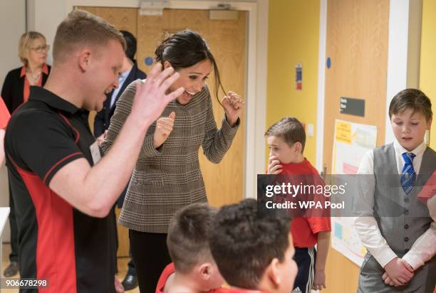 Meghan Markle watches a game of Jenga during her visit to Star Hub on January 18, 2018 in Cardiff, Wales.