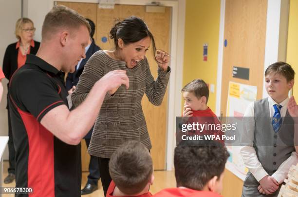 Meghan Markle watches a game of Jenga during her visit to Star Hub on January 18, 2018 in Cardiff, Wales.