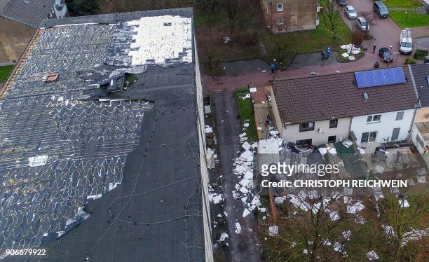 Picture taken with a drone on January 18, 2018 in Duisburg, northern Germany, shows the damage caused by strong winds at a secondary school. -...