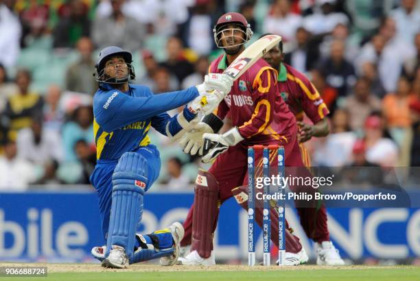 Sri Lanka batsman Tillakaratne Dilshan hits a delivery from West Indies' bowler Chris Gayle for six during his innings of 96 not out in the ICC World...