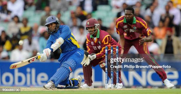 Sri Lanka batsman Tillakaratne Dilshan hits a delivery from West Indies' bowler Chris Gayle for six during his innings of 96 not out in the ICC World...
