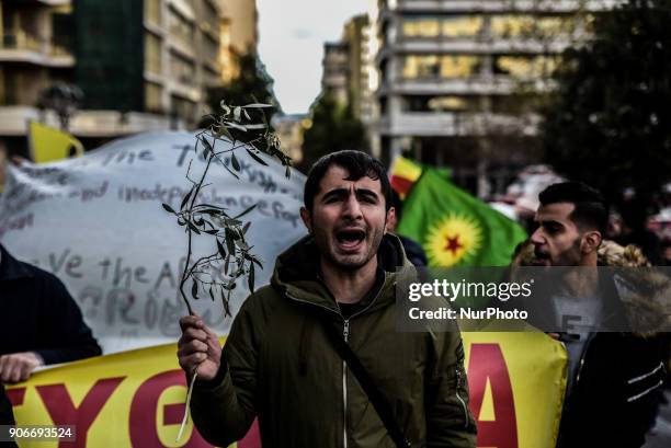 Kurdish in Athens, hold a portrait of Kurdistan Worker's Party jailed leader Abdullah Ocalan and flags, during a protest in support of Afrin, in...