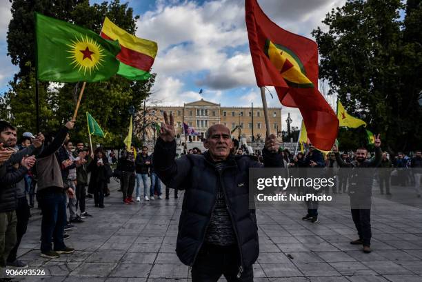 Kurdish in Athens, hold a portrait of Kurdistan Worker's Party jailed leader Abdullah Ocalan and flags, during a protest in support of Afrin, in...