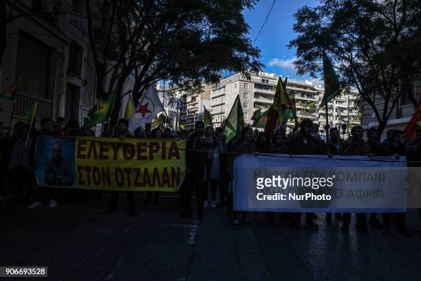 Kurdish in Athens, hold a portrait of Kurdistan Worker's Party jailed leader Abdullah Ocalan and flags, during a protest in support of Afrin, in...